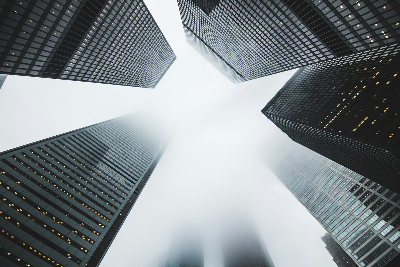 Skyward Grid - Upward view of skyscrapers forming a pale opening. Museum-grade framed artwork by Veriando Studio.
