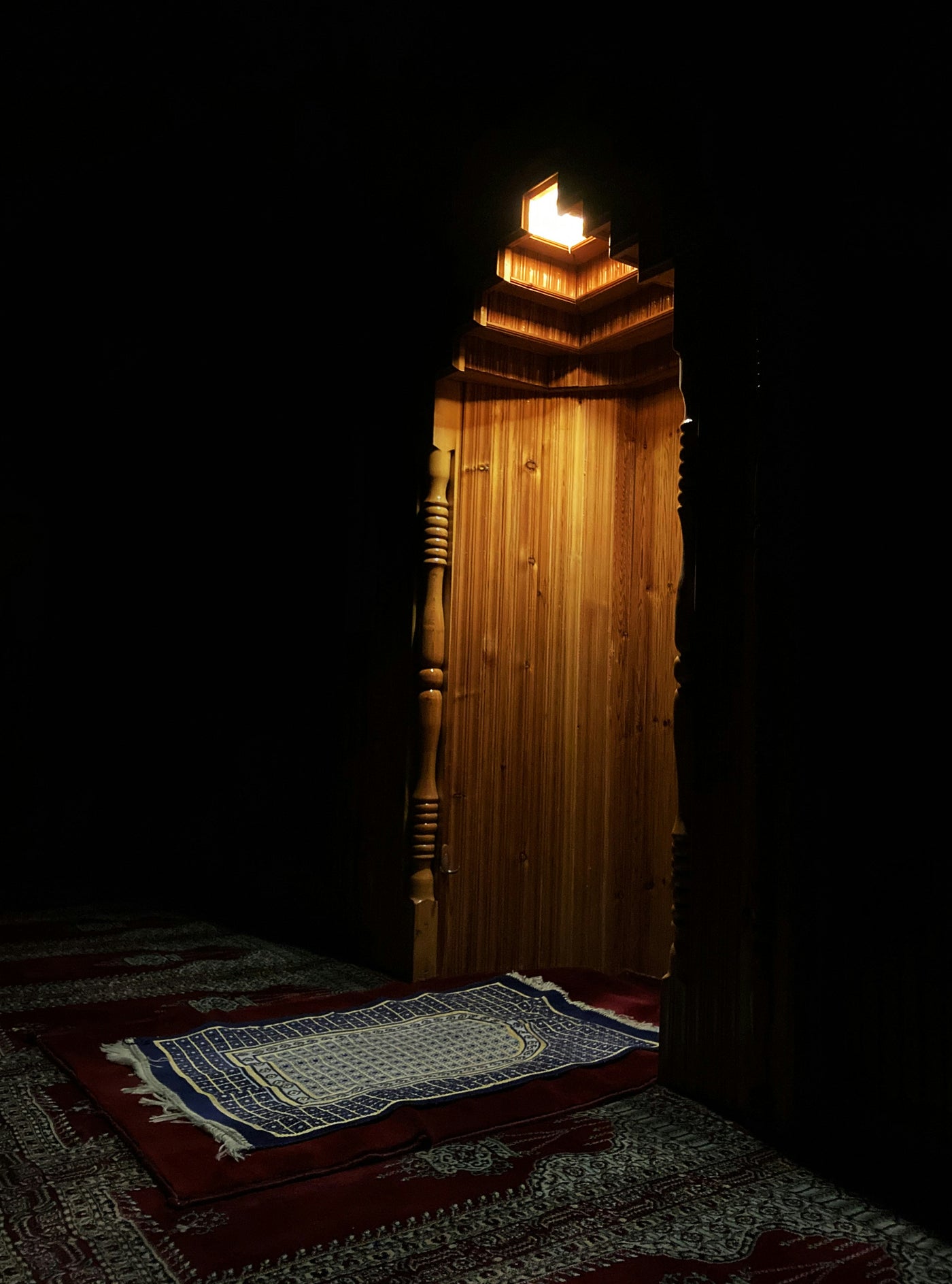 Prayer Room of Light - Prayer mat before a softly lit doorway. Museum-grade framed artwork by Veriando Studio.