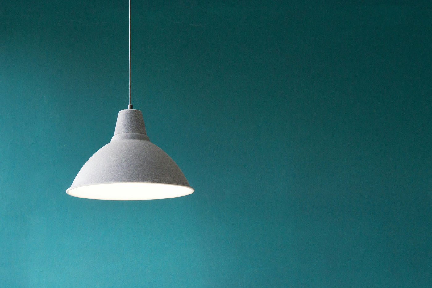 Pendant in Teal Silence - Single white pendant light against teal wall. Museum-grade framed artwork by Veriando Studio.