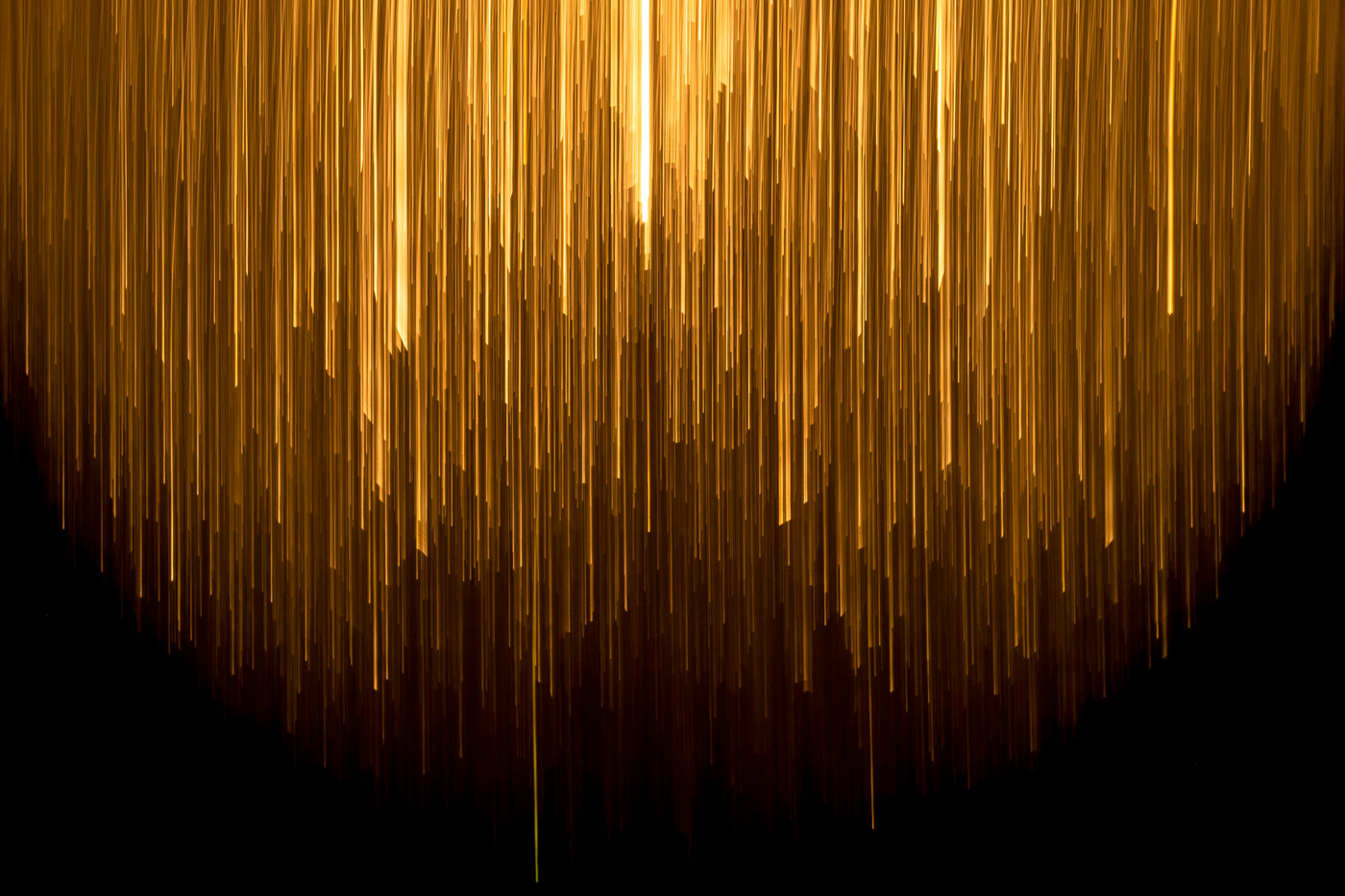 Golden Rainfall - Vertical golden light trails falling into darkness. Museum-grade framed artwork by Veriando Studio.
