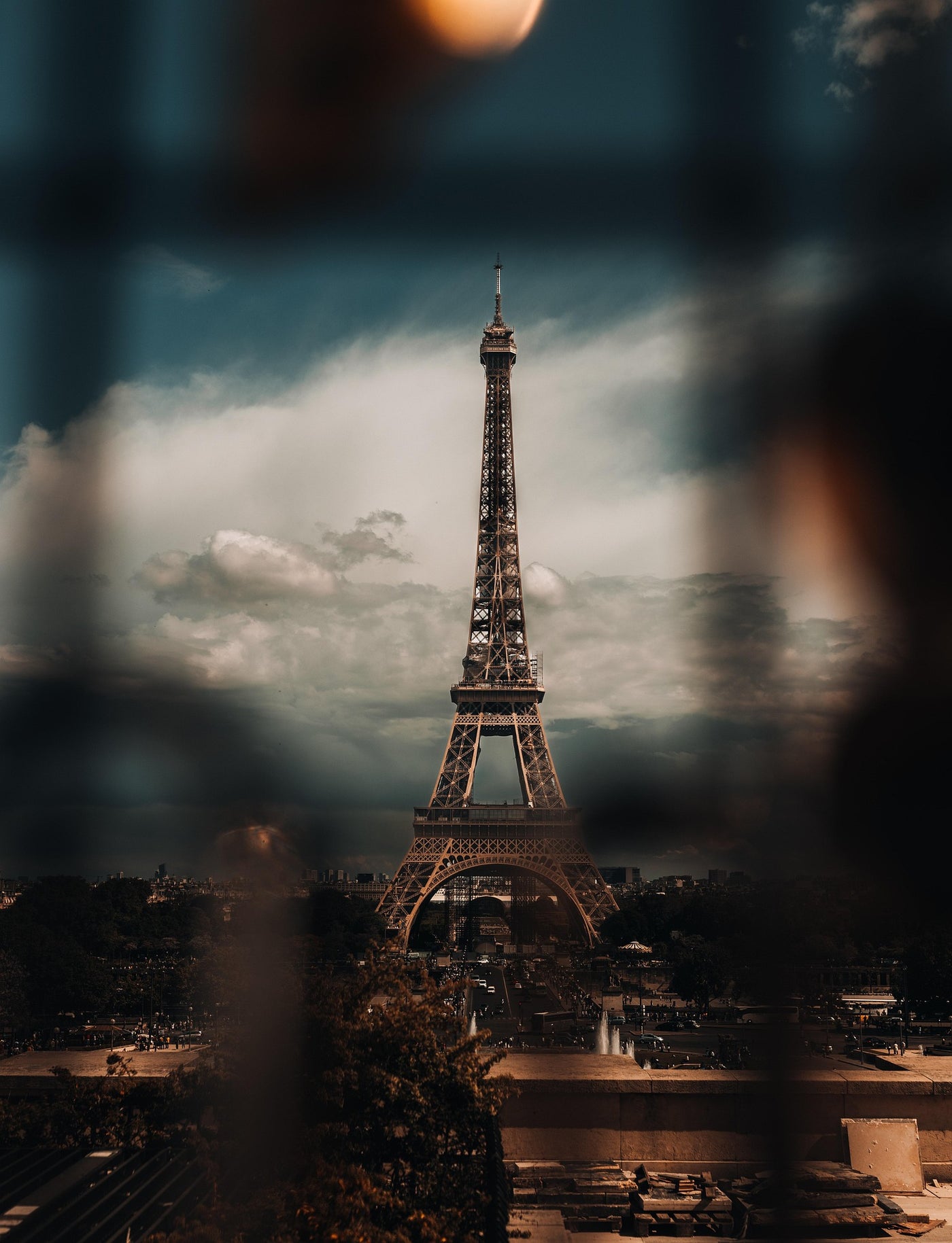 Eiffel Through Rain - Eiffel Tower framed through blurred rain and shadow. Museum-grade framed artwork by Veriando Studio.
