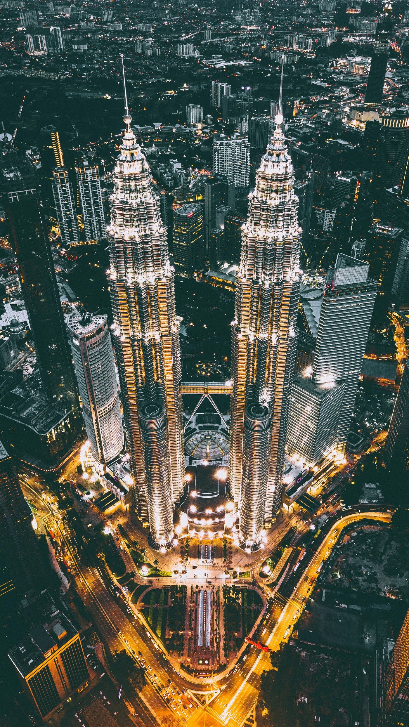 Petronas Night Axis - Aerial night view of twin towers glowing vertically. Museum-grade framed artwork by Veriando Studio.