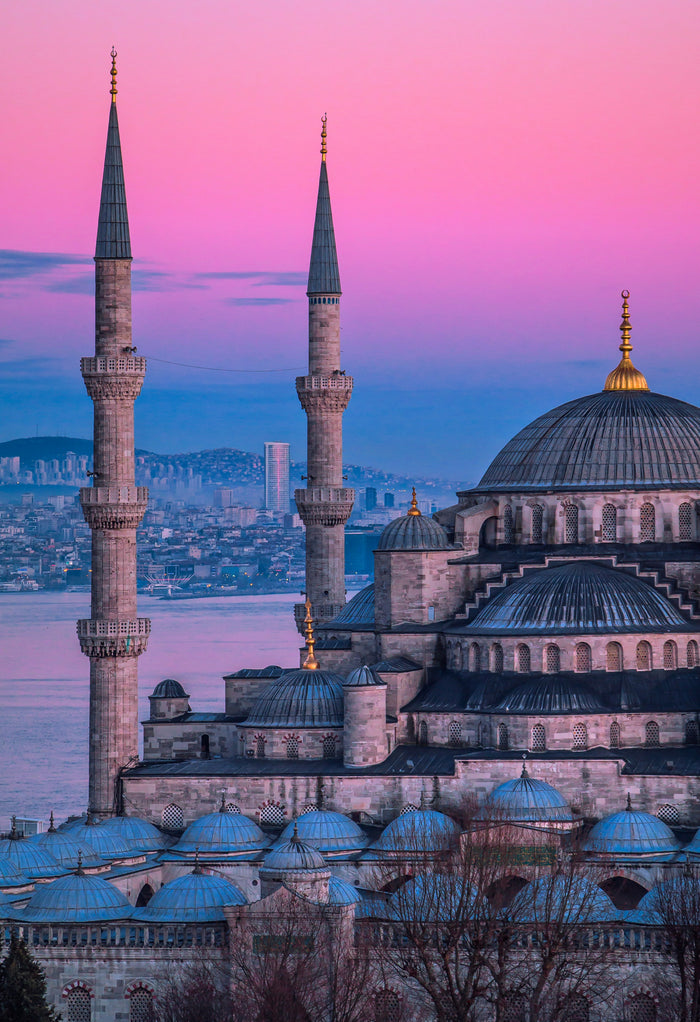 Blue Mosque Rose Hour - Blue Mosque rooftops and minarets in rose evening light. Museum-grade framed artwork by Veriando Studio.