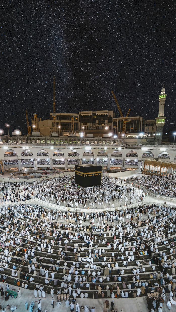 Courtyard of Pilgrimage - Kaaba and pilgrims at night. Museum-grade framed artwork by Veriando Studio.