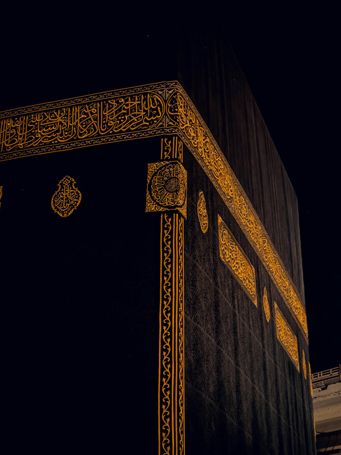 Kaaba Corner at Night - Kaaba corner and gold embroidery in dark light. Museum-grade framed artwork by Veriando Studio.