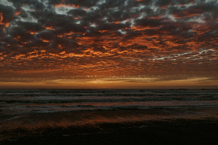 Ember Sea Horizon - Fiery sunset clouds above a dark sea horizon. Museum-grade framed artwork by Veriando Studio.