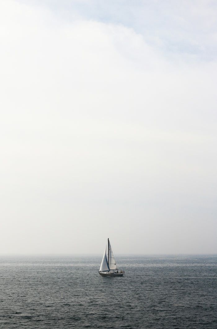 Sailboat in Pale Weather - Small sailboat in a misty pale sea. Museum-grade framed artwork by Veriando Studio.